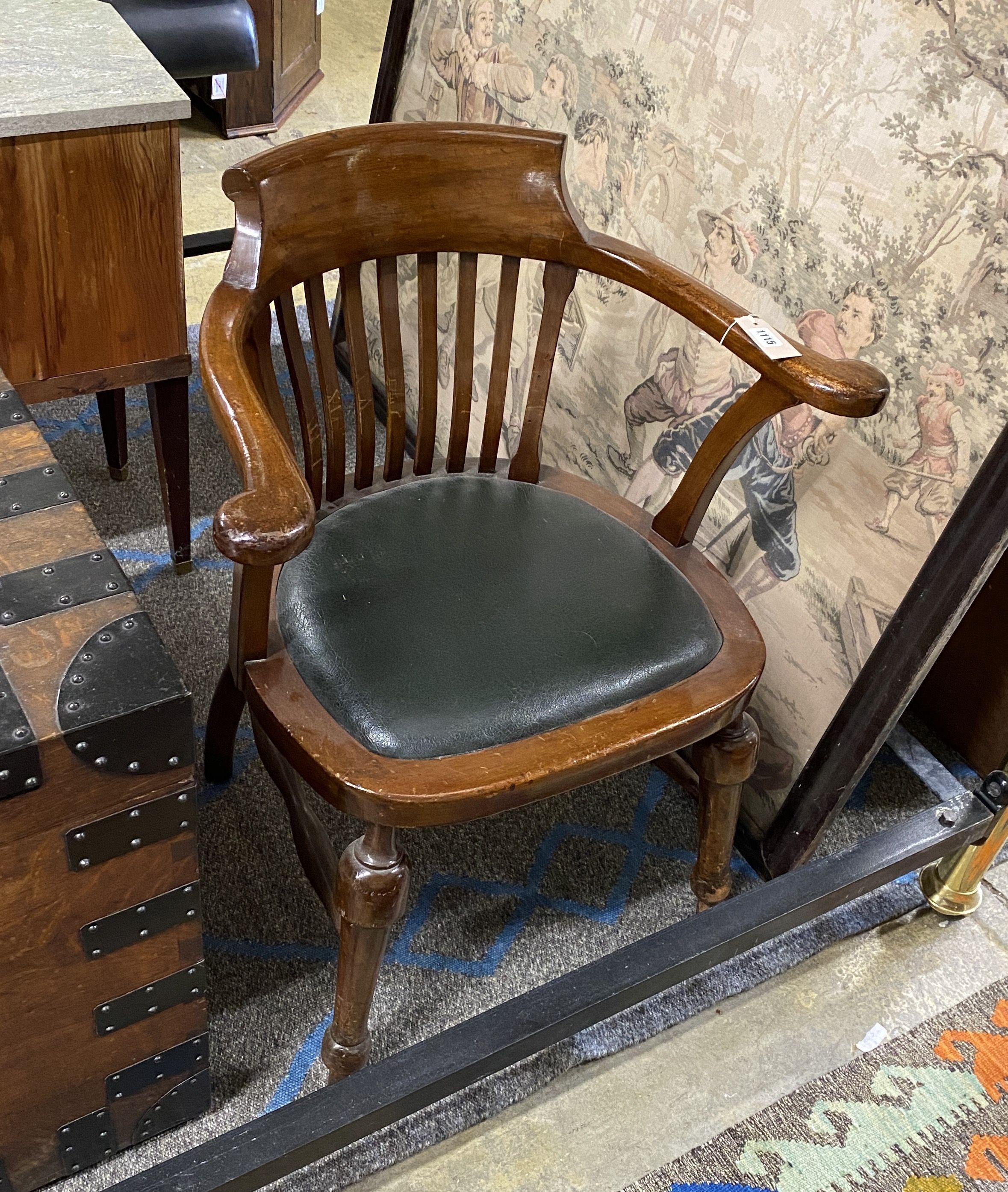 An early 20th century mahogany desk elbow chair